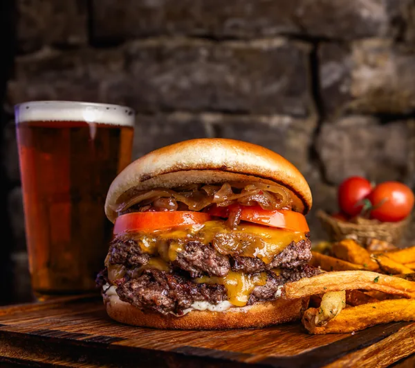 Mickey Burkes smash burger with a cold draft