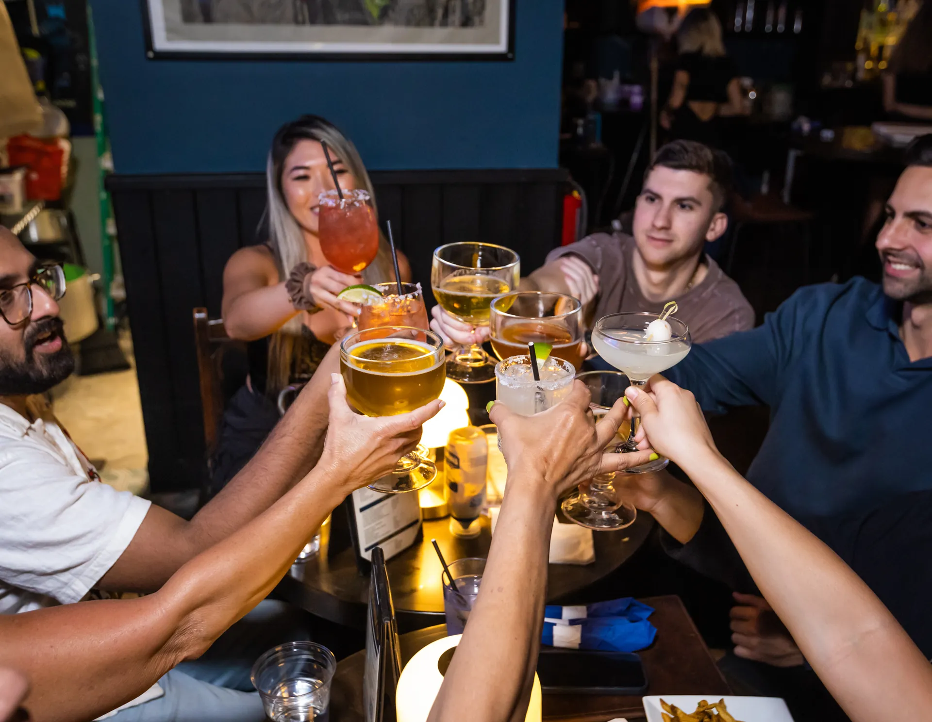 Friends raising cocktails at Mickey Burkes